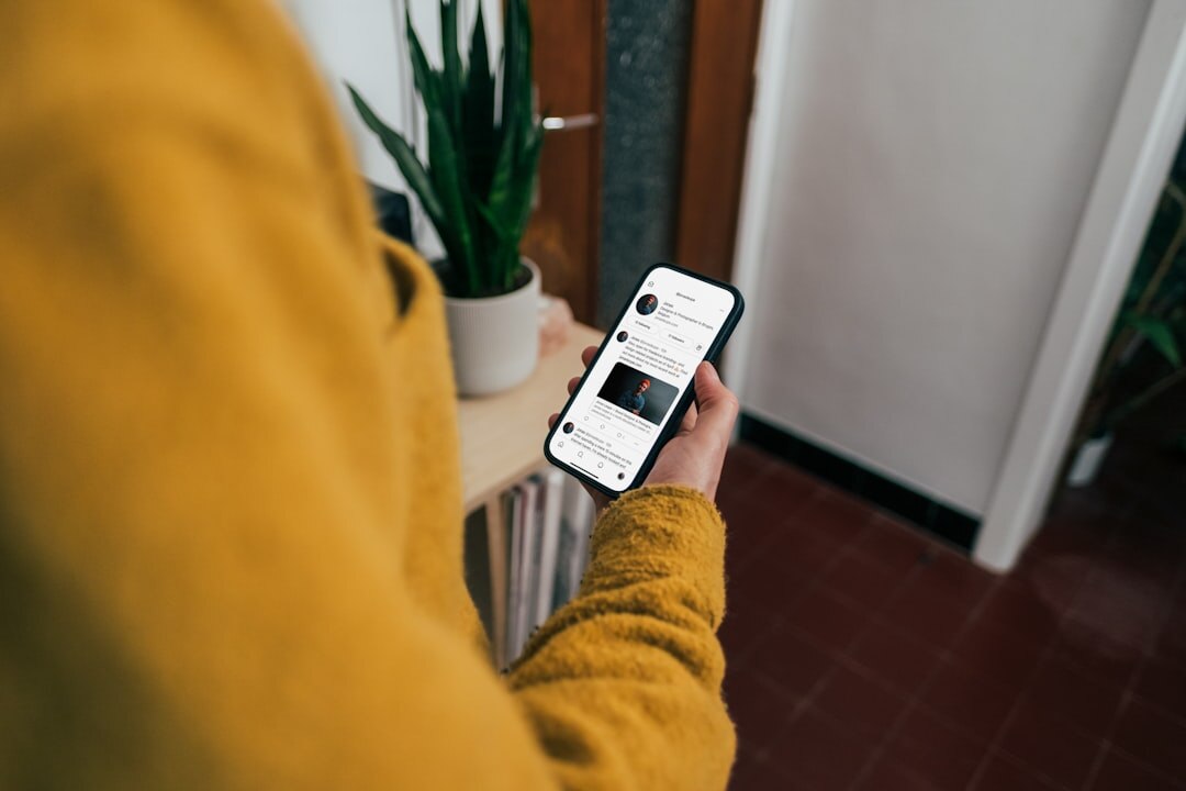 Person reading news on a smartphone at home